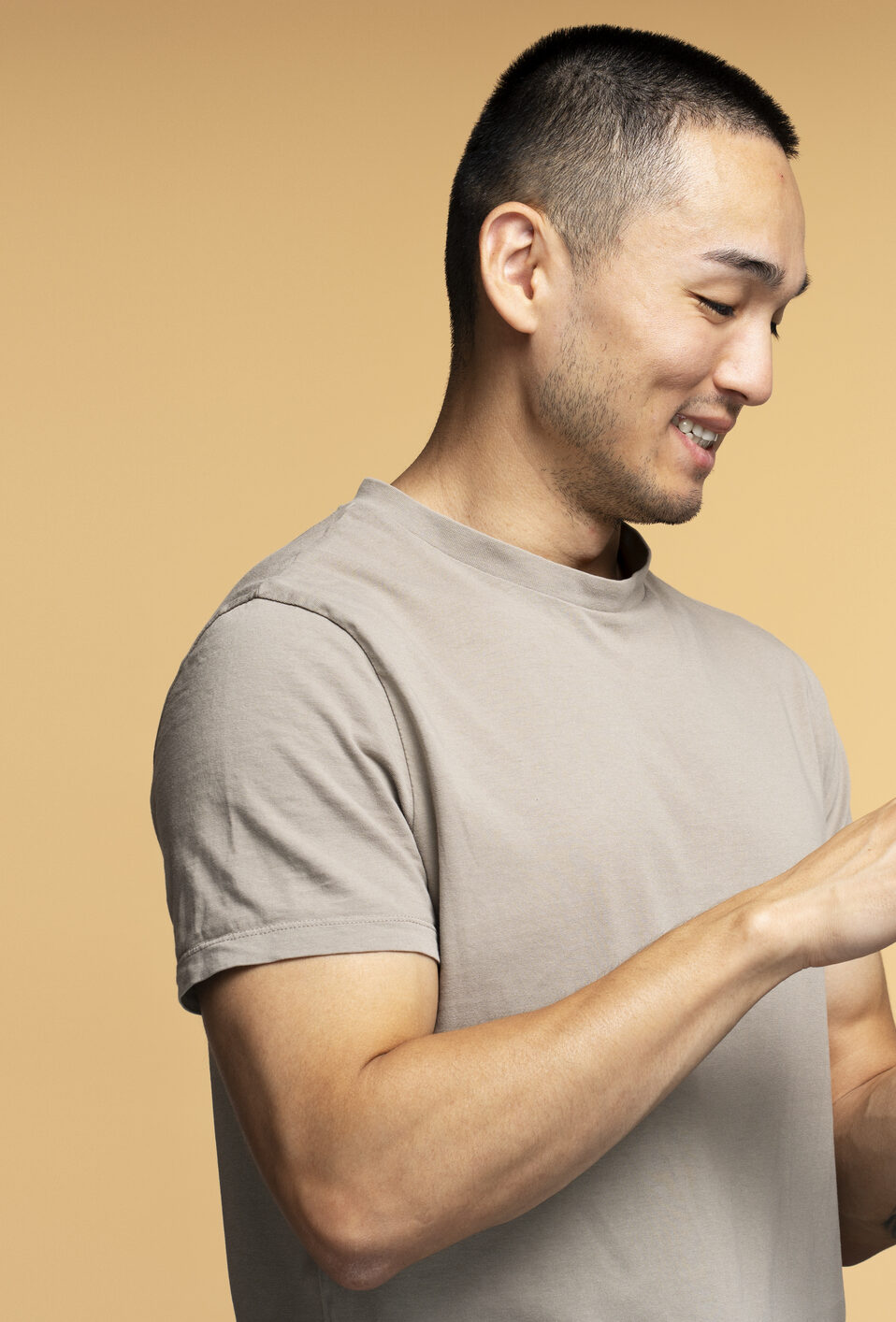 Happy man using smartphone on beige background Publicidad 360° Móvil: El Smartphone como Centro de Estrategias de Marketing Integrado